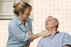Physician examines patient's neck